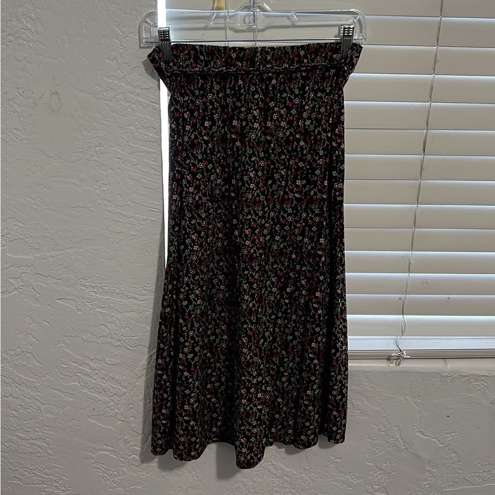 Calf length skirt with little flowers on it and a belt around the waist